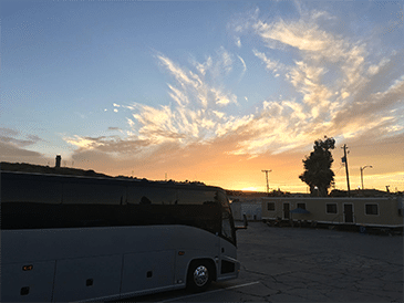 50 passenger charter bus at sunset